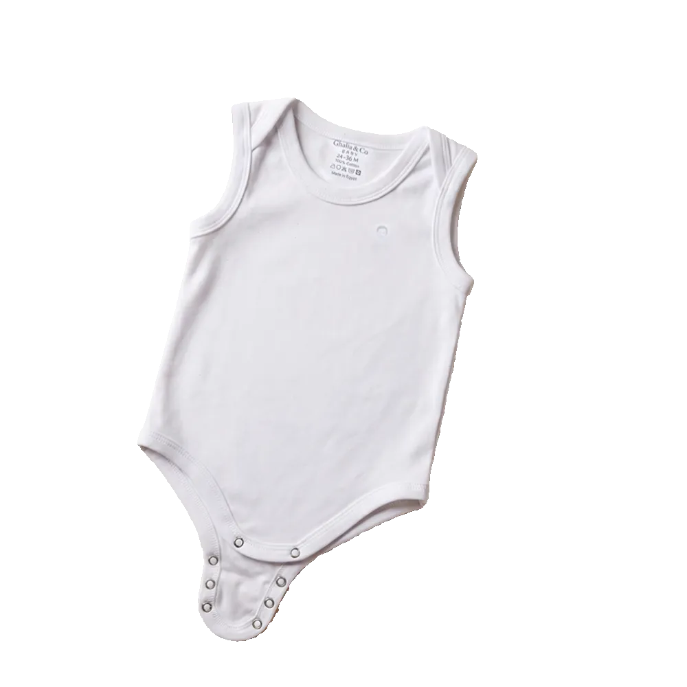 White baby onesie on a beige surface with colorful star and cloud decorations and a teddy bear.
